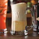 a glass mug filled with liquid sitting on top of a wooden table