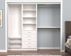 an empty white closet with drawers and shelves