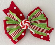 RED POLKA DOT AND LIME GREEN PEPPERMINT CANDY BOW **The size of the pictured bow is 5 inches,  but can be ordered in other sizes. Hair bows may be made with a french barrette or an alligator clip (as shown).  ITEM DETAILS *Ribbon Type: Base Layer- red polka dot Top Layer- shiny lime green and red striped Embellishment center: polymer clay round peppermint candy *BOW DIMENSIONS: 4", 5", or 6" *CLASP: French Barrette, or Alligator Clip *Edges are heat sealed to prevent fraying *Assembled by hand using sewing and hot glue PRETTY PACKAGING** Gift Ready** Each purchase will be sealed in a clear cellophane bag with sparkly confetti and tied up with ribbon.  Ships from Charlotte, NC. Red Polka Dot Top, Christmas Peppermint, Christmas Bow, Packaging Gift, French Barrette, Peppermint Candy, Pretty Packaging, Red Polka Dot, Christmas Bows