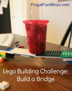 a lego building challenge build a bridge with cups and blocks on the table next to it