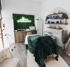 a room with white walls and green plants on the wall