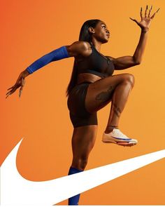 a woman is jumping in the air with her leg up