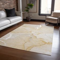 a living room filled with furniture and a large rug on top of a hard wood floor