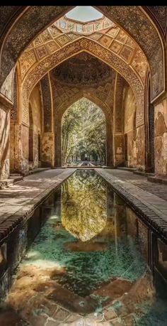 an arched walkway with water in the middle