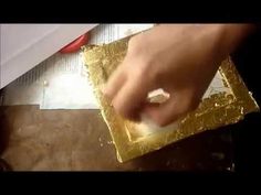 a person is peeling gold foil with a knife