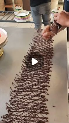 someone is cutting chocolate cake with a knife