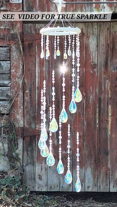 a wind chime hanging from the side of a wooden building with words see video for true sparkle