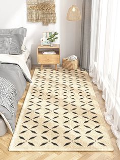 a bed room with a neatly made bed and a rug on the floor next to it