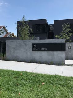 the front entrance to an apartment building with grass in front of it and a sign that reads 17 north road