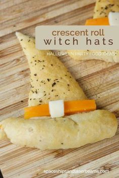 cheese and cracker roll witch hats on a wooden cutting board with text overlay