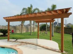 a backyard with a swimming pool and wooden pergolan arbor in the foreground