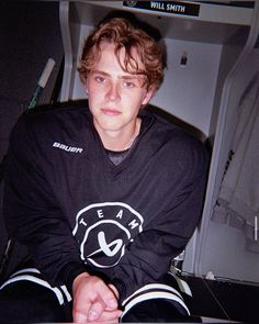 a young man sitting in front of a laptop computer