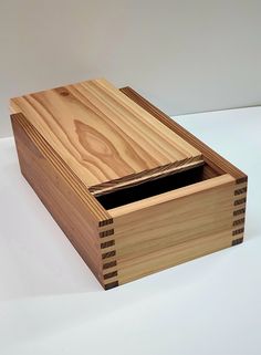 a small wooden box with two compartments on the inside