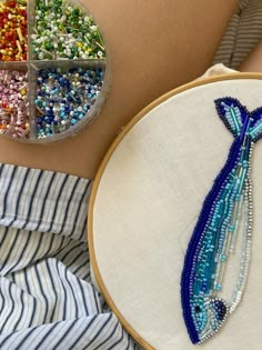 a close up of a person's stomach with beaded items in the shape of a mermaid tail