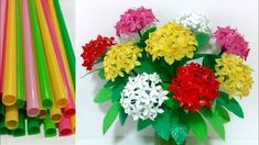 several different colored plastic straws and flowers in a vase