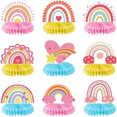 a bunch of paper decorations that are on a white background with rainbows and stars