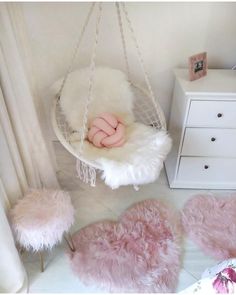 a baby's room with pink and white decor