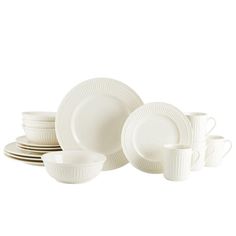 white dishes and cups are stacked on top of each other