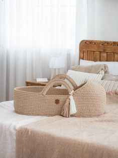 a wicker basket sitting on top of a bed