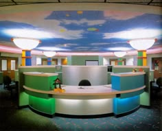 the interior of an office building with colorful lights and circular desks in front of it