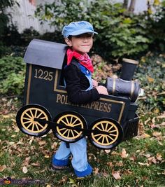 a young boy dressed up as a train conductor