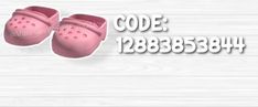 a pair of pink shoes sitting on top of a white wooden floor next to the words code