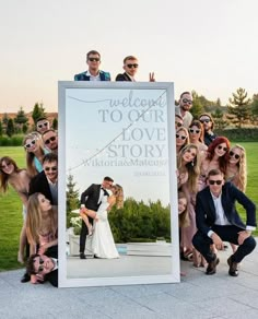 a group of people posing in front of a welcome to our love story sign with sunglasses on