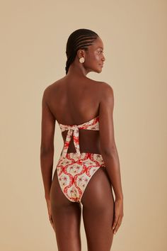 Embrace the vibrancy of summer with the FARM Rio Summer Beach Bikini Bottom. Its vivacious red and white pattern draws inspiration from tropical havens, making every moment feel like a sunny escape. The flattering high-leg cut and comfortable mid-rise waist complement your natural silhouette, while the playful tie-back detail on the coordinating top adds a touch of whimsy to your beach ensemble. Ideal for those who love to stand out with a touch of Brazilian flair. Composition 85% POLYAMIDE 15% ELASTANECare Instructions MAXIMUM WASHING TEMPERATURE 30°C, MILD PROCESS, DO NOT BLEACH, TUMBLE DRYING POSSIBLE, DO NOT IRON, DO NOT DRY CLEANSize and Fit Inches XXS XS S M L XL Bust N/A N/A N/A N/A N/A N/A Waist 22 25 27 28 30 31 Length N/A N/A N/A N/A N/A N/A Hip 34 37 39 40 43 43 Floral Bandeau Swimwear For Beach, Summer Bandeau Swimwear With Floral Print, Vacation Bandeau Swimwear With Floral Print, Bold Print Beachwear Swimwear For Summer, Bandeau Swimwear With Floral Print For Vacation, Red Swimwear For Beach Party Vacation, Printed Swimwear For Summer Parties And Vacation, Bandeau Swimwear For Beach Season Vacation, Bandeau Swimwear For Vacation Beach Season