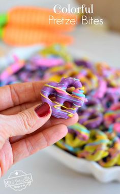 a hand holding a colorful pretzel bites