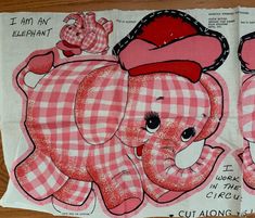 two pink elephants with hats on their heads and checkered cloths, one has an elephant's head in the center