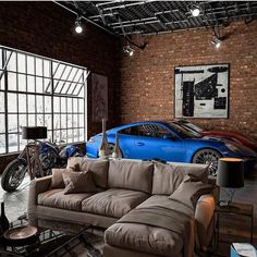 a living room filled with furniture and a blue sports car