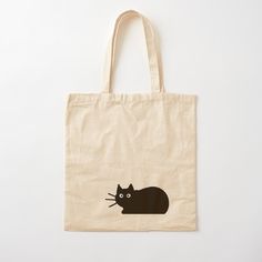 a black cat sitting on top of a beige tote bag with the word cats printed on it