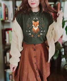 Introducing our Vintage Fox Cottagecore T-Shirt - a forest-inspired delight 🦊 Embrace the charm of Cottagecore and Forestcore styles with this whimsical tee. Let the vintage fox design transport you to a world of enchantment. Express your Green Witch spirit as you immerse yourself in the beauty of nature. Elevate your style with a touch of Boho and Indie flair. This Forest-inspired treasure is a true reflection of your unique taste. Stand out with this exceptional addition to your wardrobe! if you like our fox design but you prefer something cozy and warm to wear, check out our sweatshirt  https://www.etsy.com/listing/1540771776/cozy-cute-fox-cottagecore-sweatshirt  Here's what you need to know  ★ Fit ★ This is a unisex T-shirt. It might be a bit larger than your usual size. So, check out Boho Tshirts, Fox Shirt, Cottagecore Shirt, Estilo Hippie, Cottagecore Outfits, Cottagecore Fashion, Mode Boho, Granola Girl, Mode Inspo