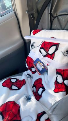 a car seat covered in spiderman blankets