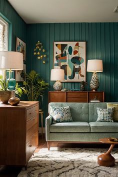 a living room with green walls and furniture in the corner, including a blue couch