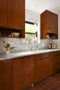 a kitchen with wooden cabinets and white counter tops