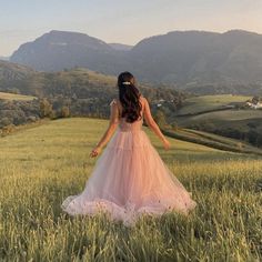 a woman standing in the middle of a field