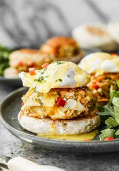 a plate with crab cakes and greens on it