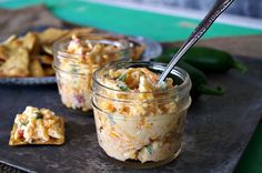 two jars filled with food sitting on top of a table