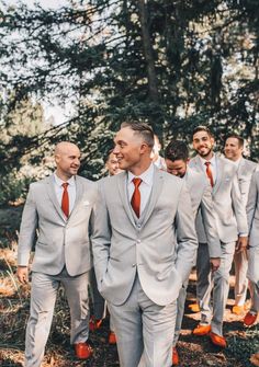 a group of men in suits and ties walking together