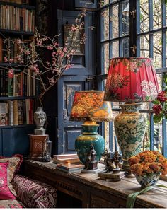 vases and lamps on a table in front of a window