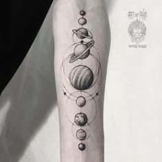 a black and white photo of an arm with different planets on the outer half of it