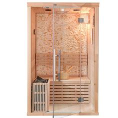 a wooden sauna with glass doors and an air heater in the corner, next to a brick wall