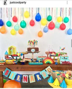 a birthday party with balloons, cake and decorations