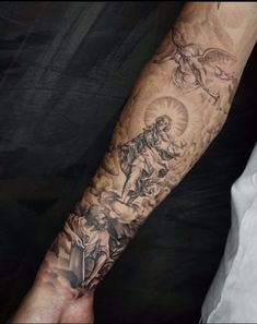 a man's arm with tattoos on it and an image of the virgin mary