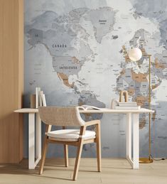 a desk and chair in front of a wall with a world map on the wall