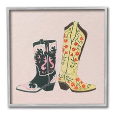 two pairs of cowboy boots with flowers on the bottom and pink background, framed in a silver frame