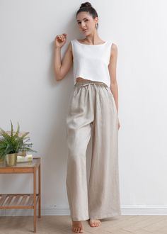 "★★FEATURES 100% Linen Two side pockets Adjustable drawstring Elastic, high waisted pants Pleated waist details Wide leg linen pants Long linen pants Perfect for Summer, Spring, Autumn ★★ Model Size Height approx 162 cm (5′ 4″) Bust 84 cm (33\") Waist 66 cm (26\") She wears size XS. ★★ Bespoke Order Service If you Request other color Request the length Your height is not between 155 cm- 172 cm Your weight is over 75 kg I can do it for you, It will need some extra fee depending on on your need. C Linen Elastic Waist Pants, Elastic Wide Leg Pants, Oversized Linen Pants Outfit, Linen Beach Pants Outfit, Taupe Linen Pants Outfit, Wide Leg Pants Linen, High Waist Linen Pants, Loose Flowy Pants, High Humidity Outfits