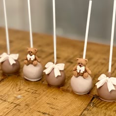 chocolate candies with teddy bears in them on a wooden table