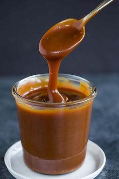 a spoon pouring chocolate into a cup